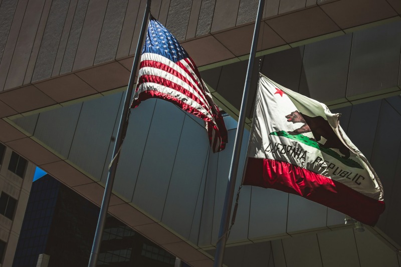 California flag and American flag outside government building