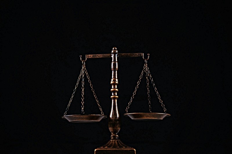 Justice scales against black background