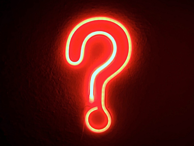 Question mark symbol on red neon sign